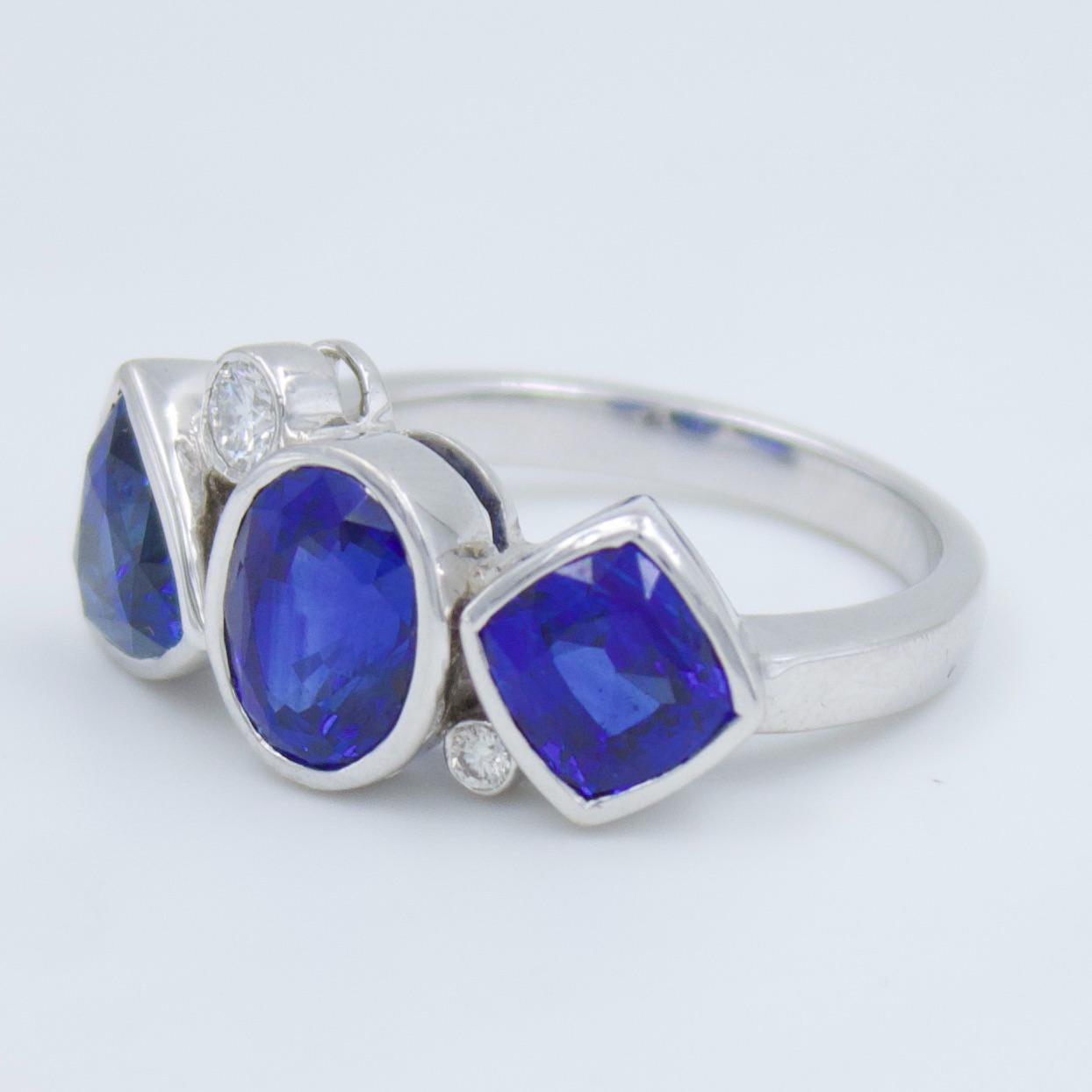 Luxurious IGI Certified 6.42 Ct Intense Blue Ceylon Sapphire Statement Three Stone Ring in 18K White Gold